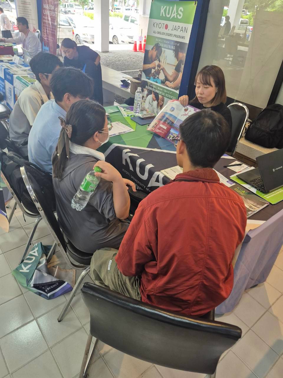 Students consulting representatives at the Kyoto University of Advanced Science booth during the Study in Japan Fair
