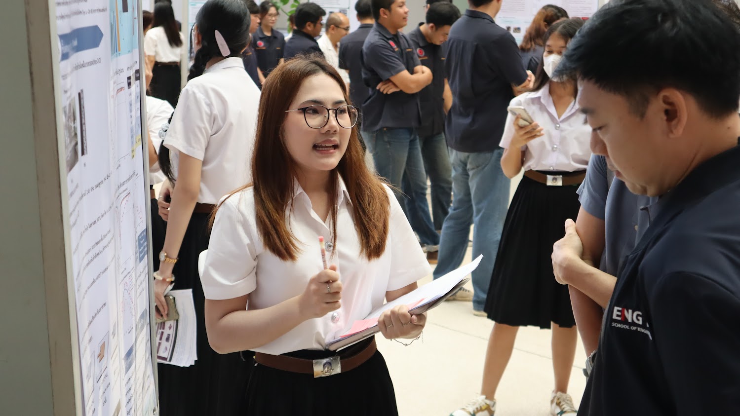 Napaphat Rueangwong discussing her engineering project with visitors during the Project Day poster session